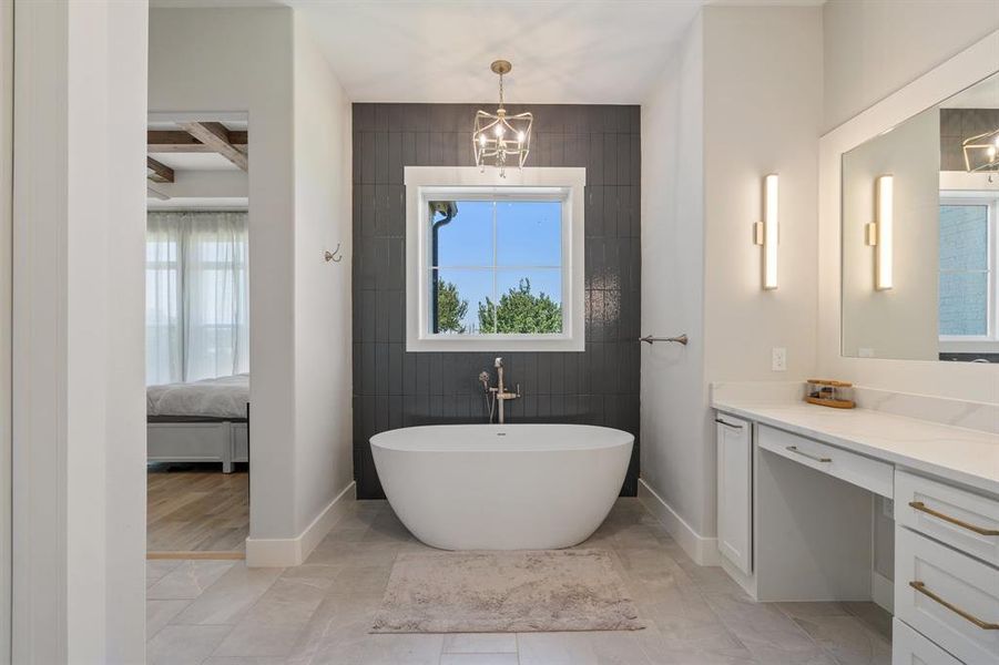 Bathroom featuring vanity, tile walls, tile floors, and a chandelier