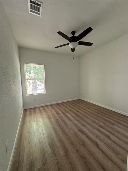 Spare room with ceiling fan and hardwood / wood-style flooring