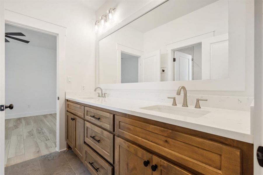 Bathroom with dual bowl vanity, ceiling fan, and hardwood / wood-style floors