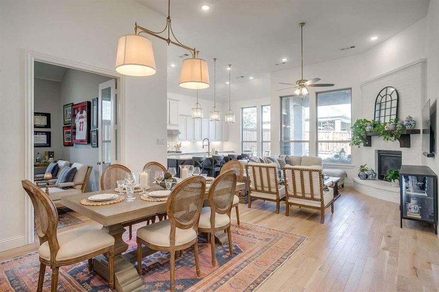 Dining space featuring ceiling fan, light hardwood / wood-style flooring, and sink