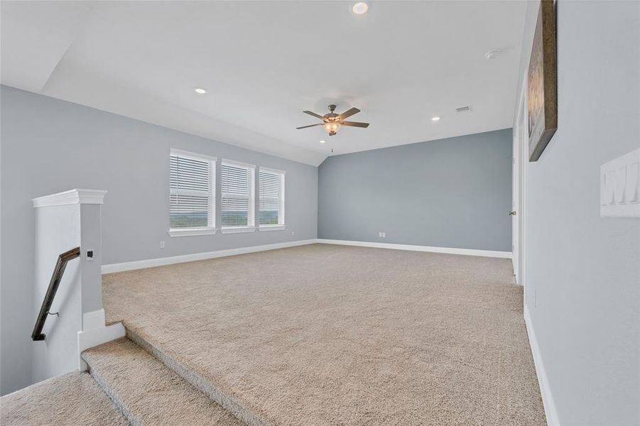 This home has living space galore with this massive play area at the top of the stairs, that leads to the theater room. Oh, and the views from those windows are amazing!