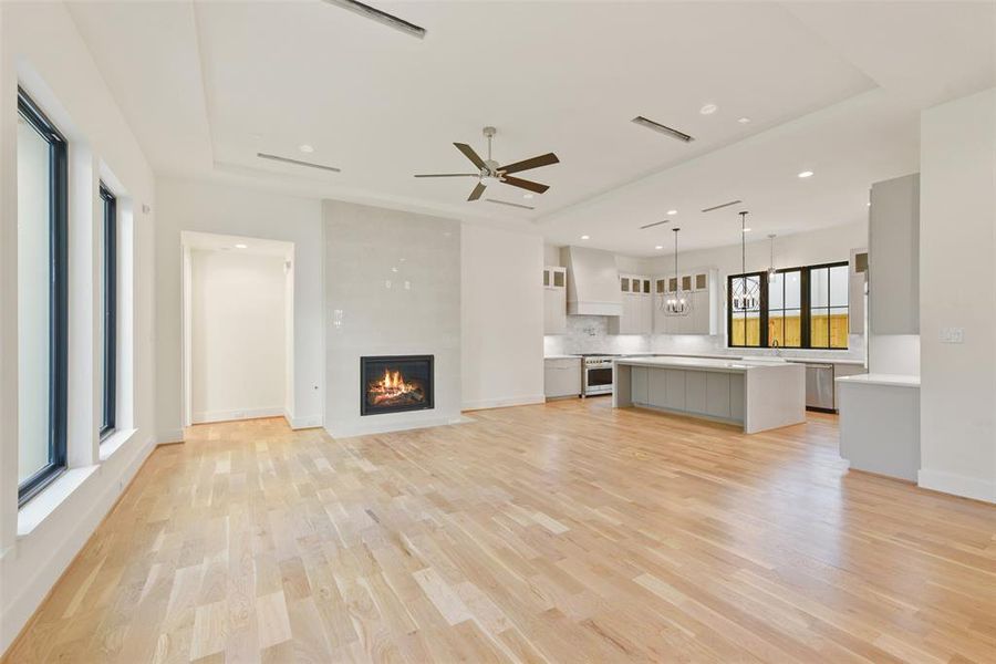 Relax and entertain in the large family room open to the kitchen. The gas log fireplace is a focal point and is wired and set for a television above it. large windows overlook the courtyard with Lanai and summer kitchen.