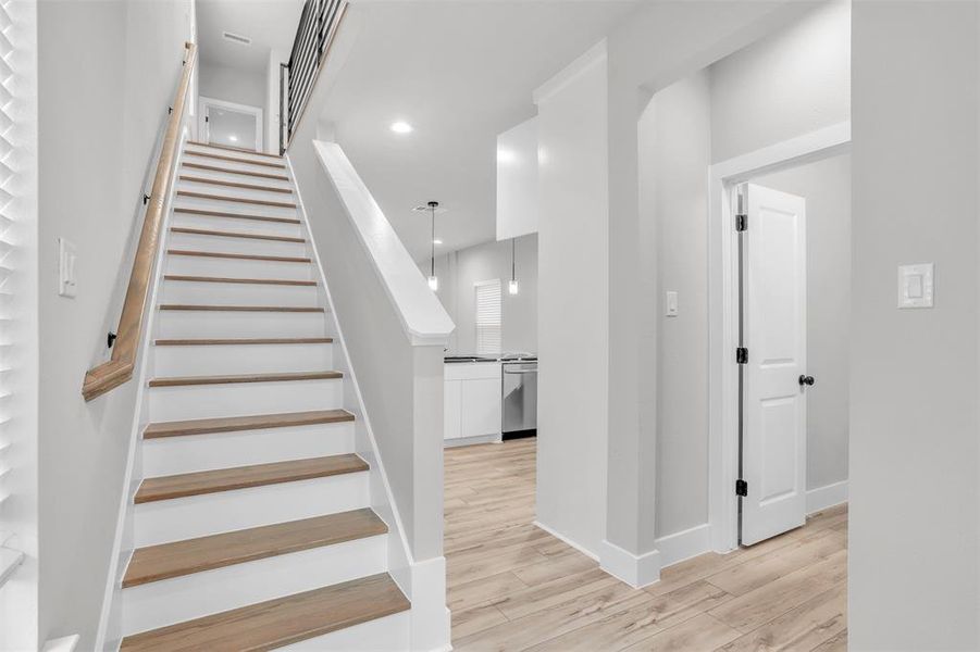 Stairs featuring hardwood / wood-style floors