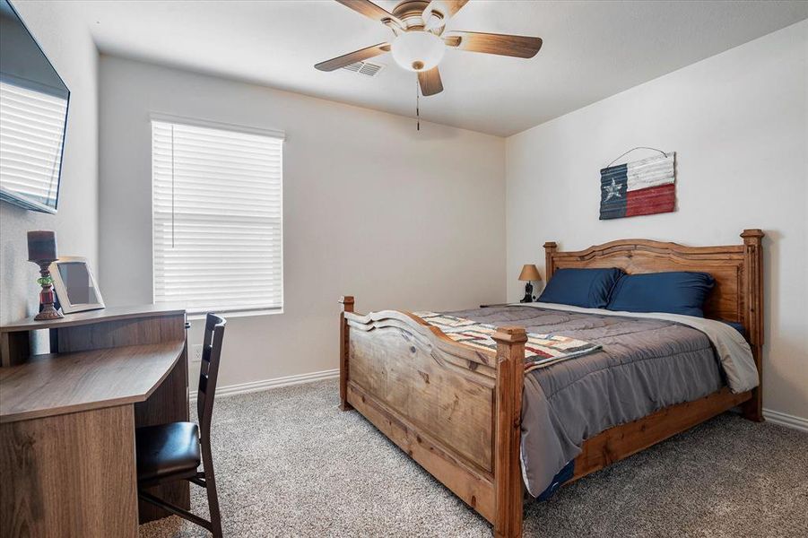 Bedroom with light carpet and ceiling fan