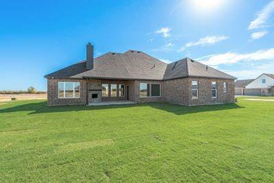 Rear view of property featuring a lawn