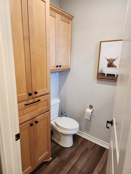 Bathroom featuring toilet and hardwood / wood-style flooring