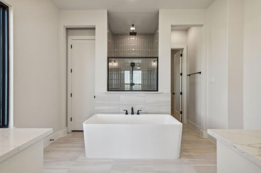 Bathroom featuring plus walk in shower and vanity