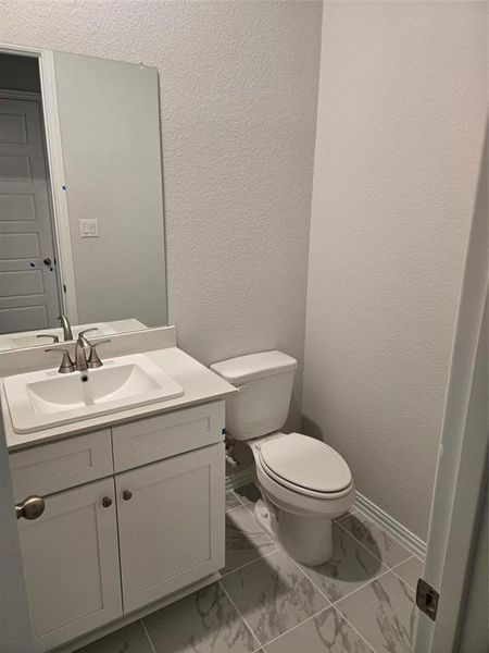 Bathroom featuring vanity and toilet