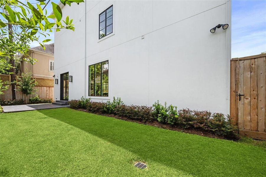 Such a fantastic backyard for you and your furry friends to enjoy! Lined with beautiful landscaping. Wooden gate leads to the extra parking space.