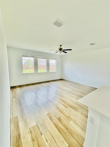 Spare room with ceiling fan and light hardwood / wood-style flooring