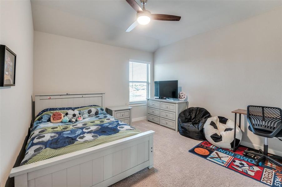 Bedroom featuring light carpet and ceiling fan