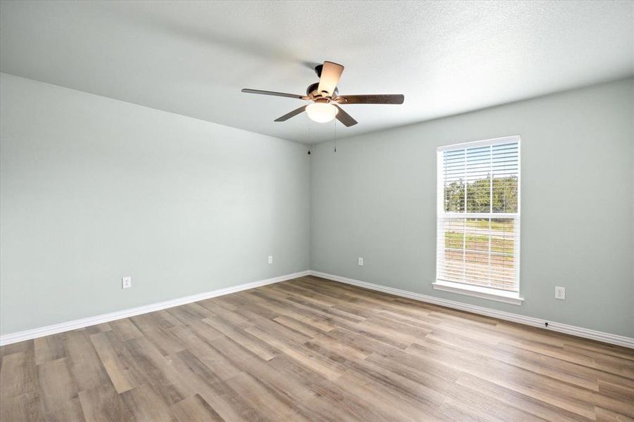 Spare room with ceiling fan and light wood-type flooring