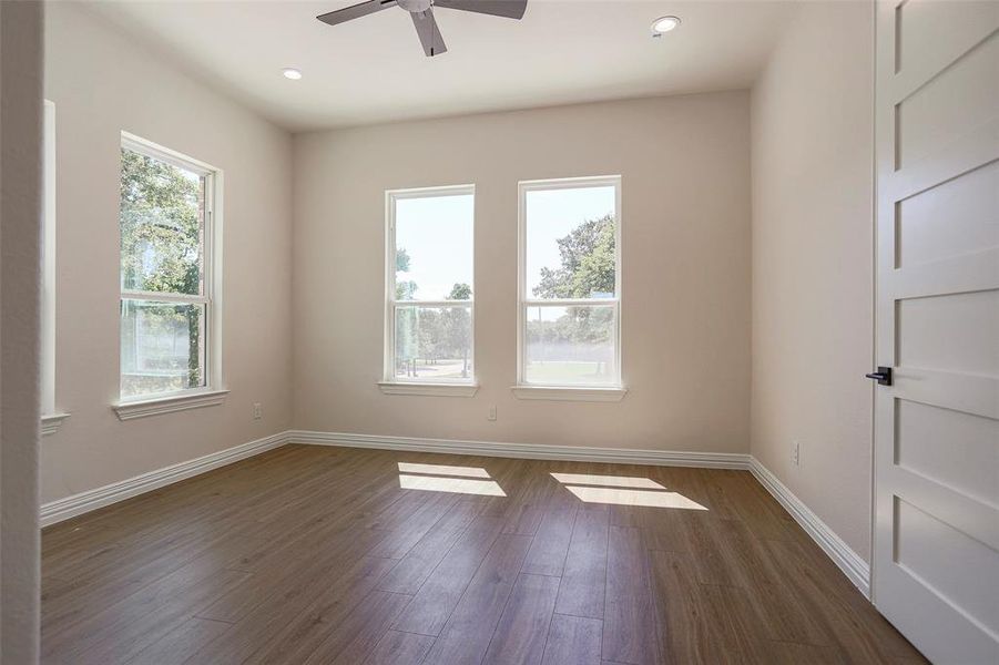 Spare room with dark hardwood / wood-style floors and ceiling fan