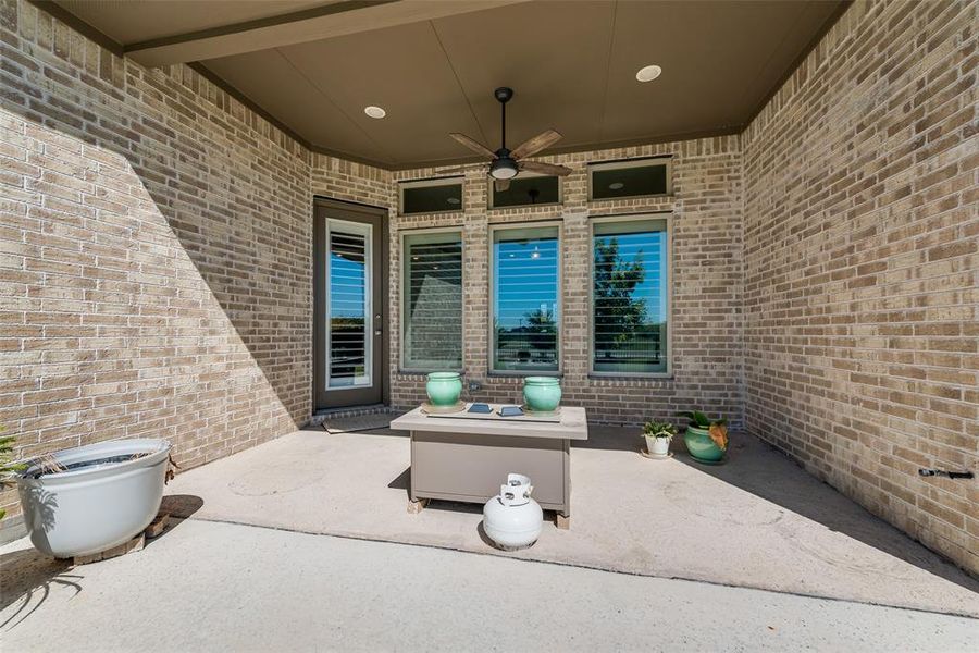 View of extended covered patio featuring ceiling fan