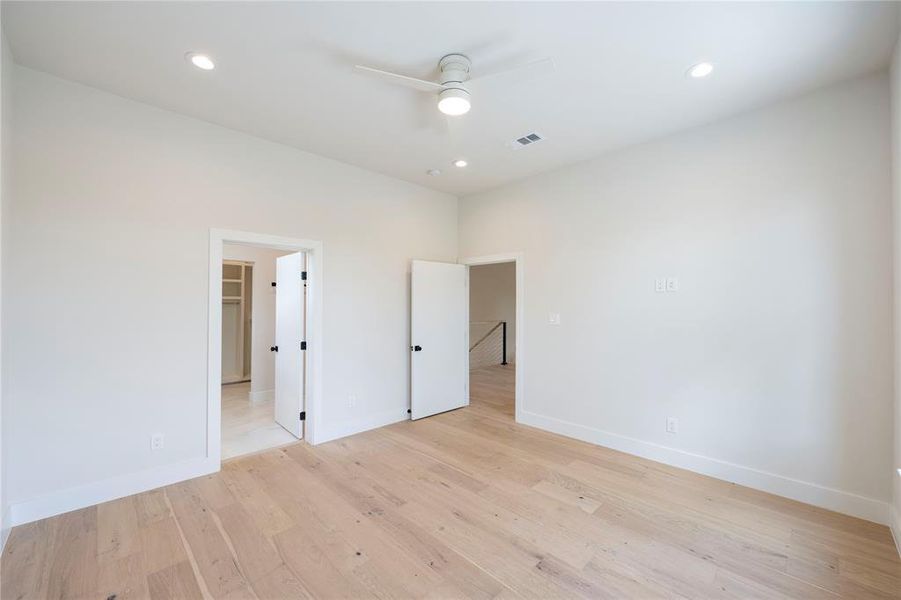 Unfurnished room featuring ceiling fan and light hardwood / wood-style flooring