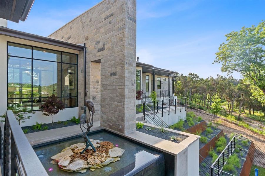 The entry foyer is flanked by two glass walls to maximize the views when you enter the home. The wing to the right of this view hosts the deluxe owner's suite and home office.