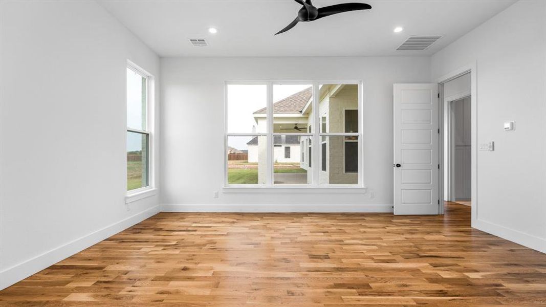 Spare room featuring ceiling fan and light wood-type flooring