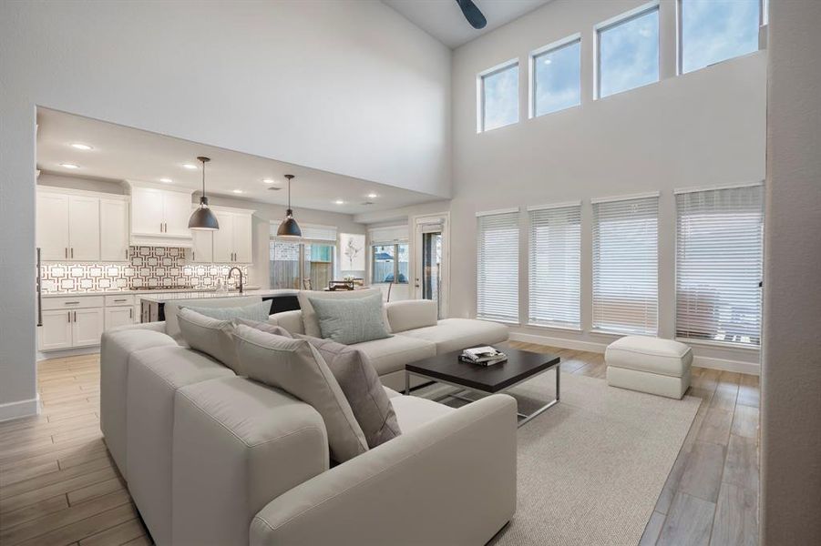 The open concept living room and kitchen makes for a great way to keep the party going and never miss a beat! With two story windows, there's plenty of natural lighting throughout the day! *This room has been virtually staged