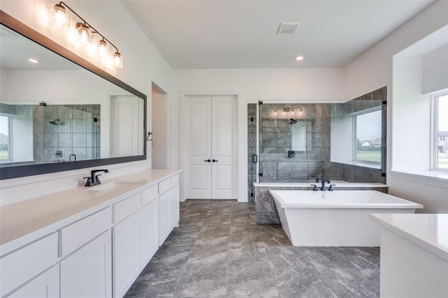 Bathroom with tile floors, separate shower and tub, and oversized vanity