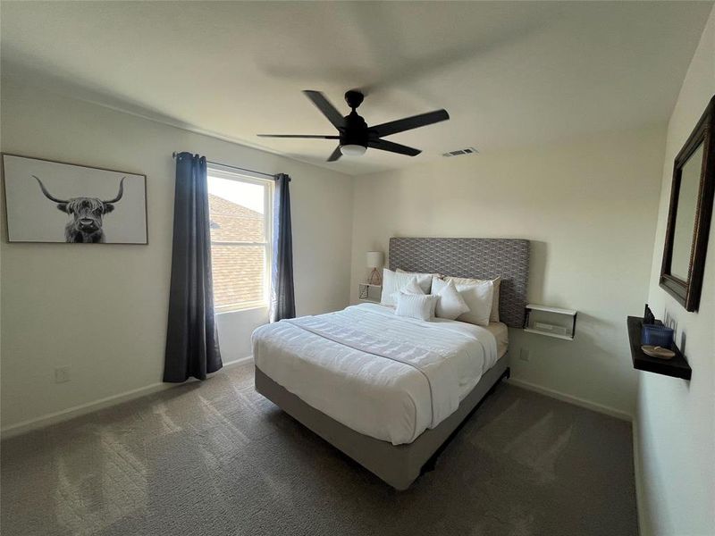 Bedroom featuring carpet and ceiling fan