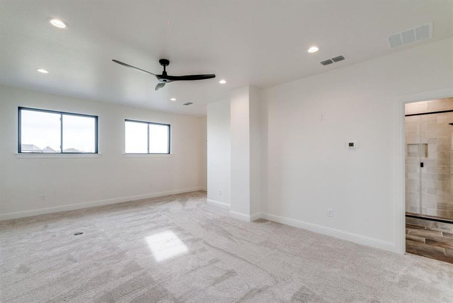 Carpeted empty room with ceiling fan