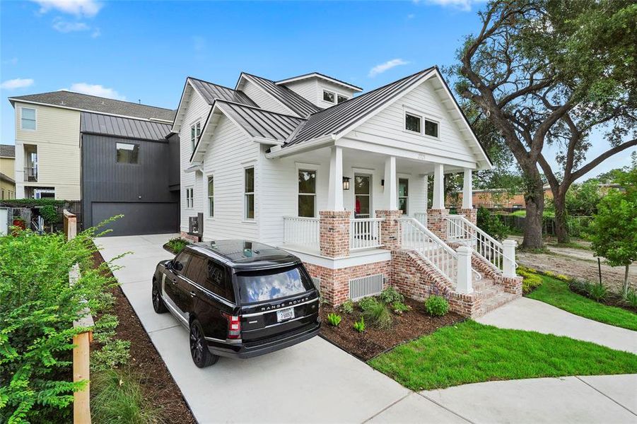 Welcome home to 2721 Morrison in the Woodland Heights! Charming white facade, inviting porch, lush landscaping, and elegant design in a serene neighborhood setting.