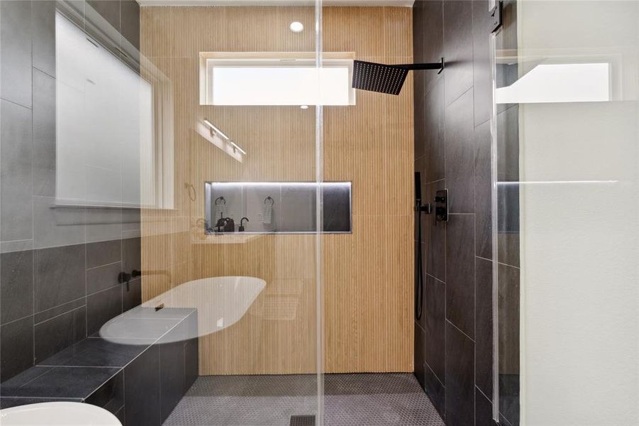 Indulge in the ultimate spa experience with this stunning walk-in shower, featuring elegant ribbon oak ceramic walls and a spacious, LED-lit shampoo niche for a touch of modern luxury