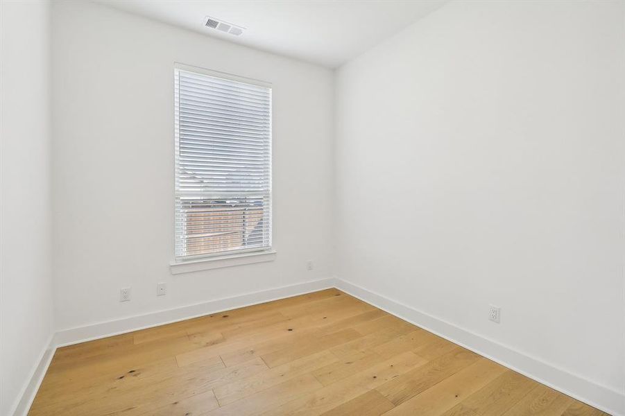 Spare room with light wood-type flooring