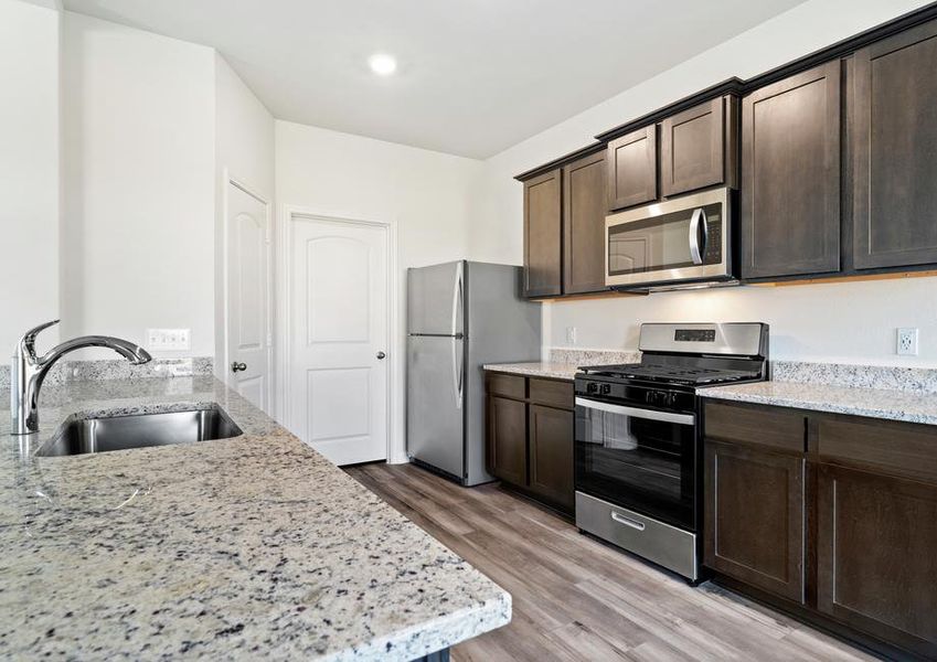 The kitchen of the Cypress has beautiful wood cabinets.