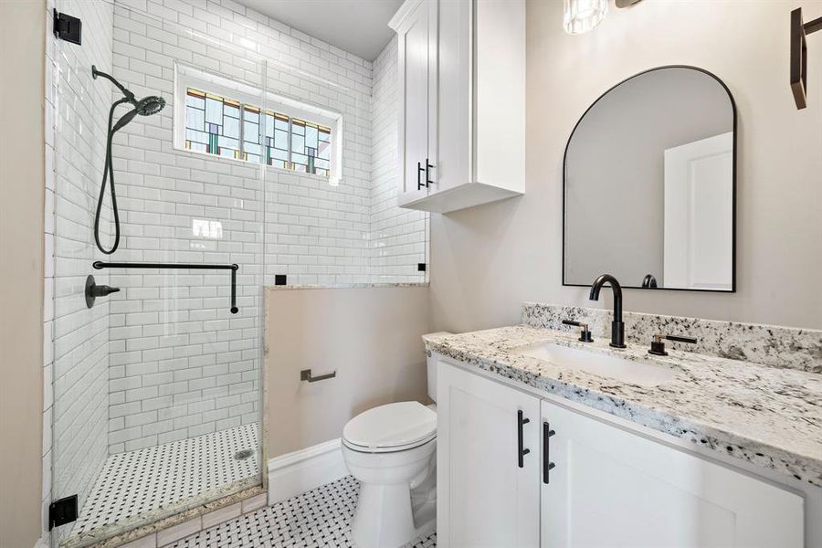 Stand up shower in the first floor ensuite. Custom cabinets and granite counters continue