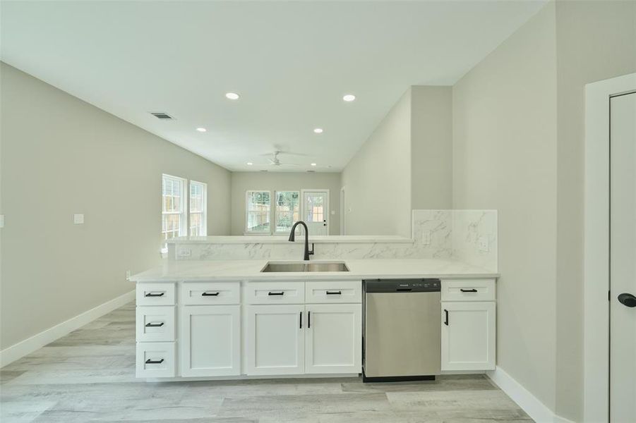 Kitchen open to the family room.  Even the cook can be in the conversation