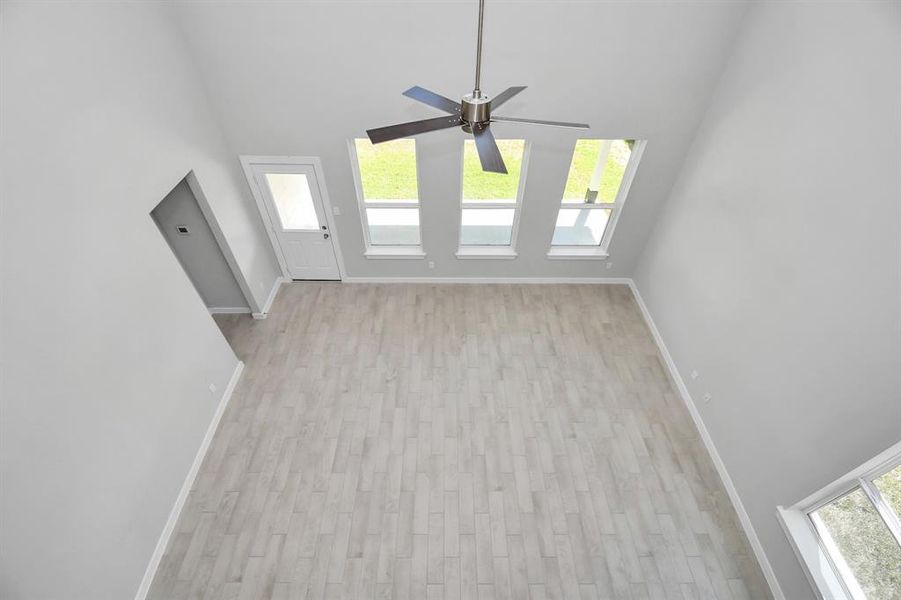 View of family room from landing above. Sample photo of completed home with similar floor plan. Actual colors and selections may vary.