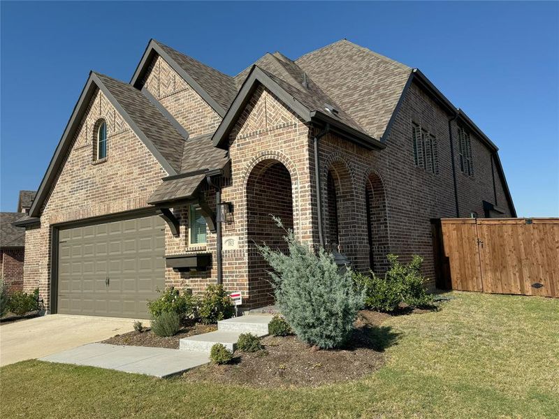 Tudor home featuring a front lawn and a garage