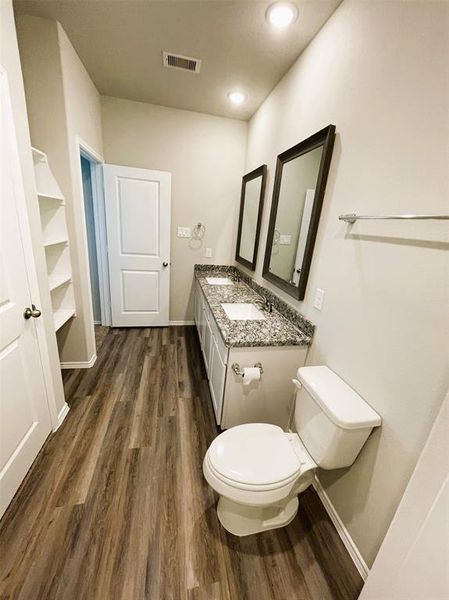 Double sinks in the en suite master bath + linen shelves, granite counters & framed mirrors!