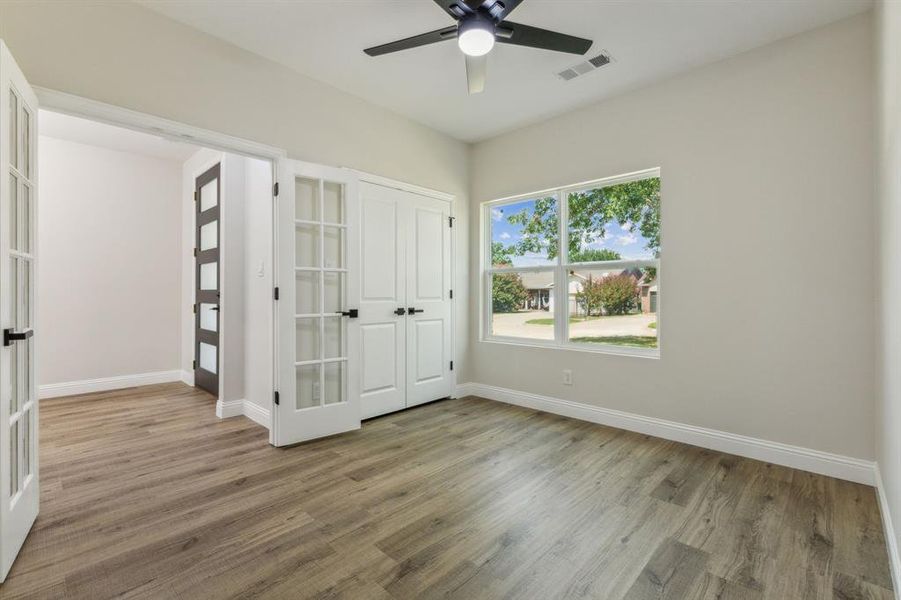 Spare room featuring ceiling fan and hardwood / wood-style flooring