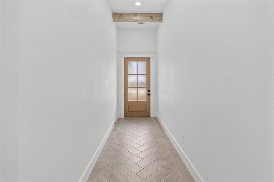 Entryway featuring beam ceiling