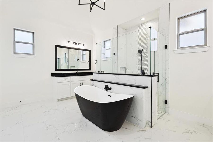 Bathroom featuring plus walk in shower, plenty of natural light, and vanity