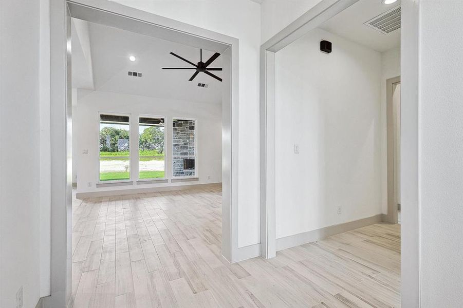 Unfurnished living room featuring light wood-type flooring and ceiling fan