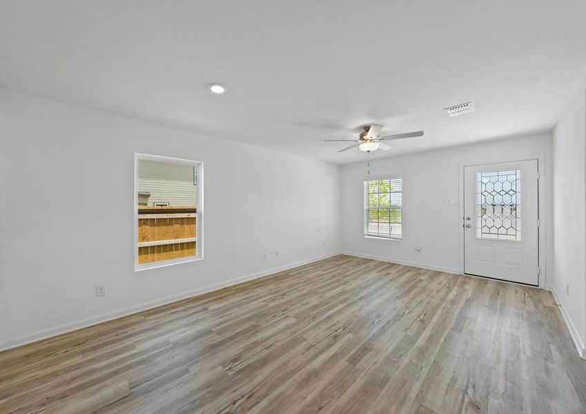 The family room has two windows a luxury vinyl flooring