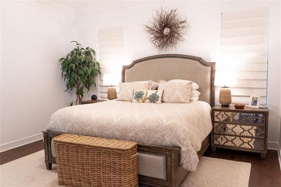 Bedroom featuring crown molding and hardwood / wood-style floors