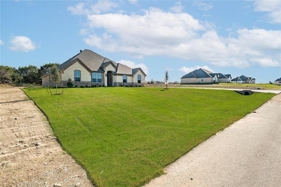 Single story home with a front lawn