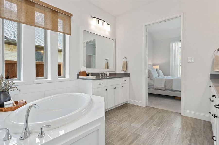 Bathroom featuring a bathing tub and vanity