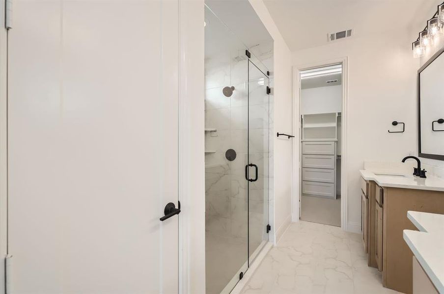 Bathroom featuring vanity and an enclosed shower