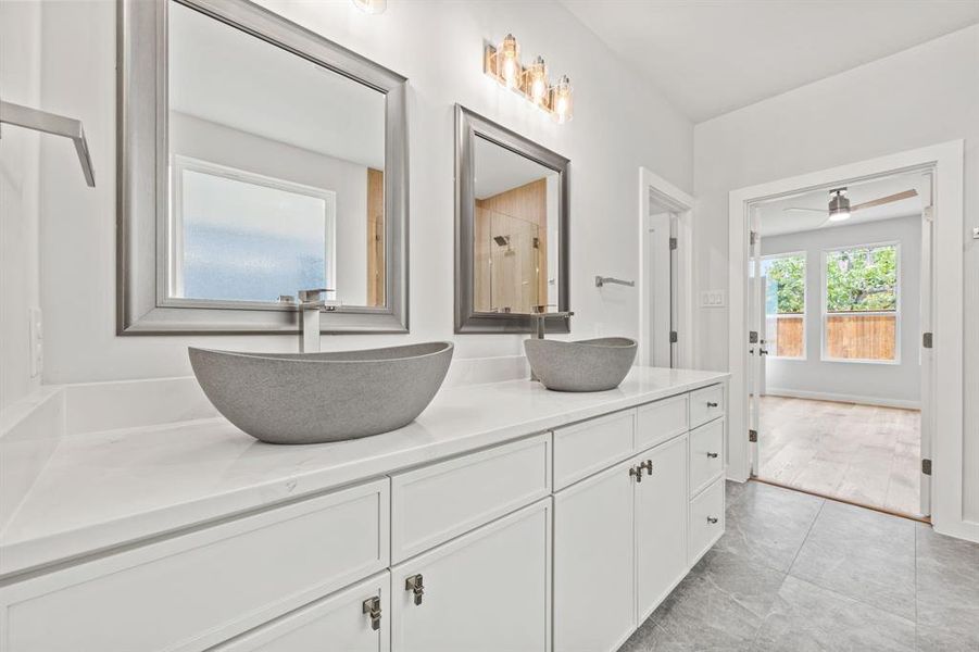 Bathroom with wood-type flooring, ceiling fan, and double vanity