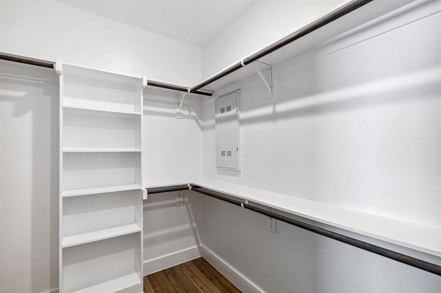 Walk in closet featuring dark wood-type flooring