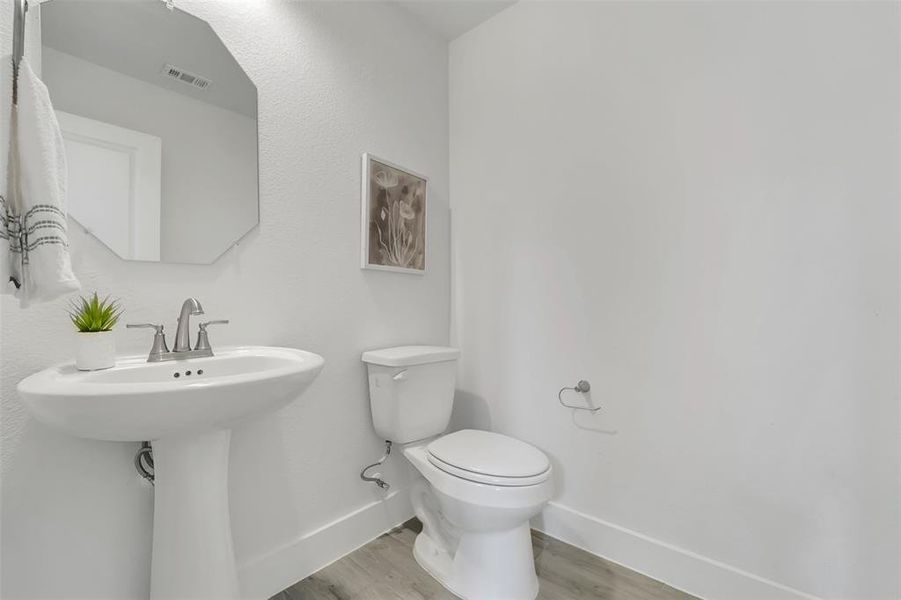 Bathroom featuring hardwood / wood-style floors and toilet