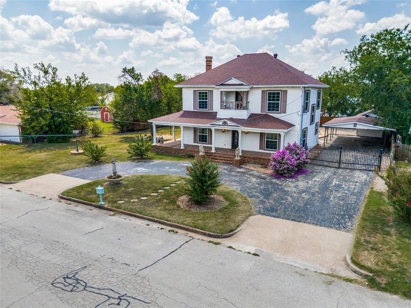 View of front of home with a front yard and covered porch