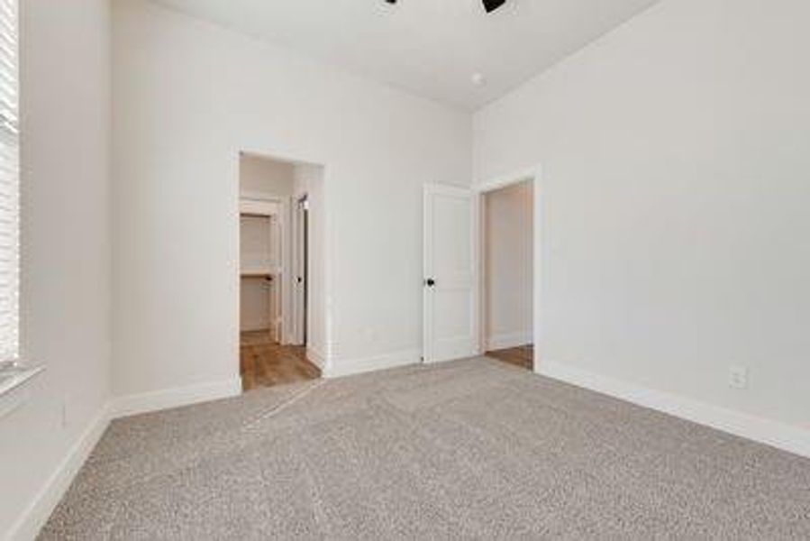 Unfurnished bedroom with light colored carpet