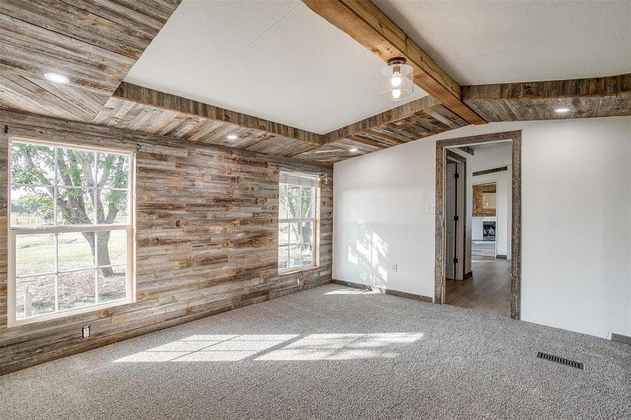 Unfurnished room with carpet and wood walls