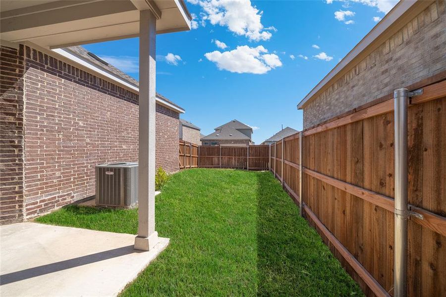 View of yard with a patio and central air condition unit